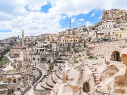 Zamek Uchisar w Kapadocji wznosi się nad miastem, otoczony domami i jaskiniami wykutymi w miękkiej skale